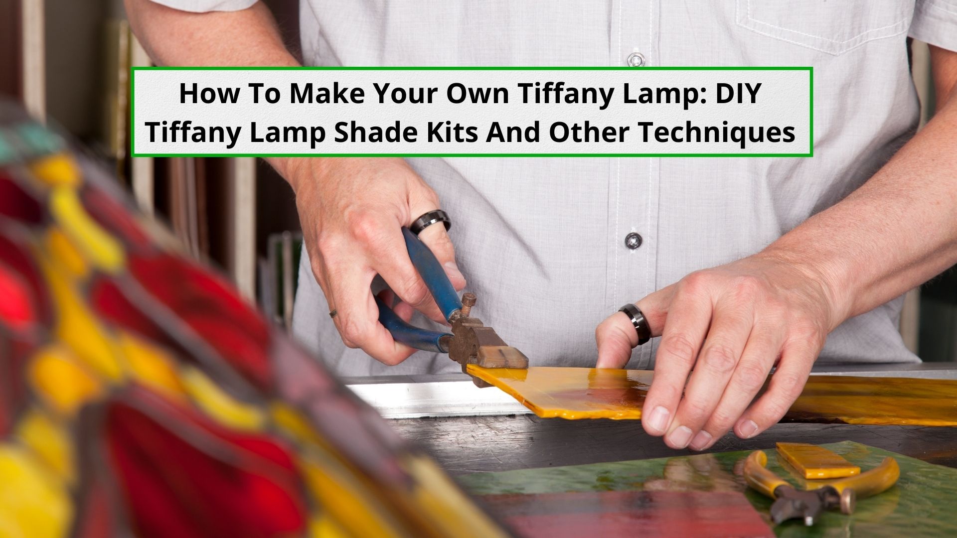 Image depicting a person cutting colored glass on a workbench for a Tiffany Lamp Shade shown to the left of image.